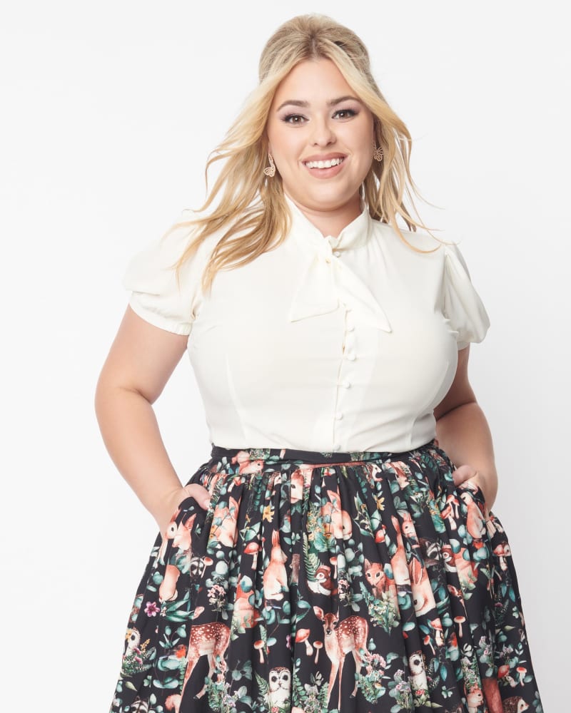 Front of a model wearing a size 2X Unique Vintage Ivory Tie Neck Button Blouse in Ivory by Unique Vintage. | dia_product_style_image_id:340680